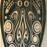 Wood Burn design of an abstract squid on cedar